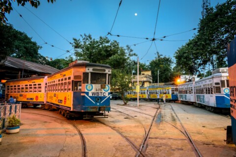 Why is Kolkata called "The City of Joy"? 31 yellow and white tram on road during daytime