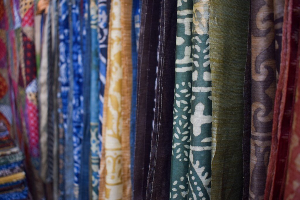 Colorful traditional Bengali sarees hanging on display at a Kolkata textile market