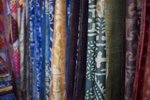 Colorful traditional Bengali sarees hanging on display at a Kolkata textile market