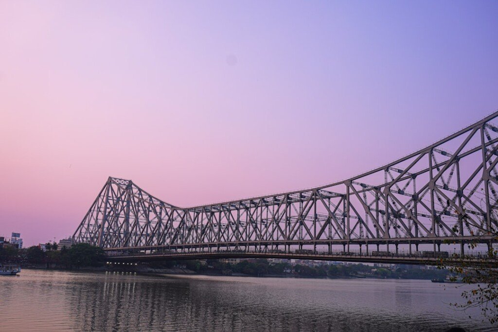 Howrah Bridge lit up at dusk over the Hooghly River, a key stop on a Kolkata itinerary