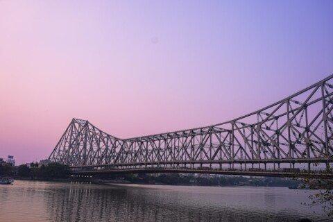 Howrah Bridge lit up at dusk over the Hooghly River, a key stop on a Kolkata itinerary