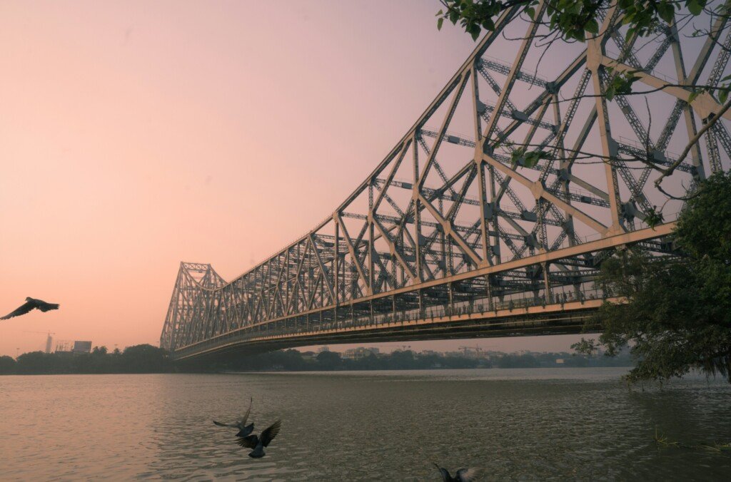 Howrah Bridge (Rabindra Setu) spanning the Hooghly River in Kolkata at sunset