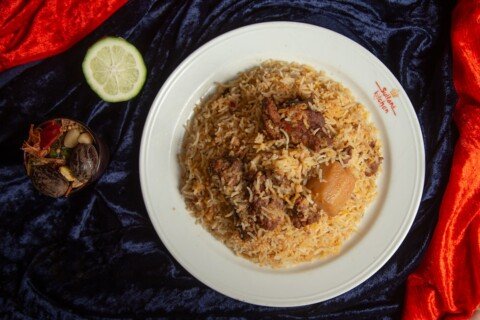 Plate of Kolkata-style mutton biryani with rice, meat, and the classic potato, as served at biryani houses like Arsalan, Aminia, and Royal Indian Hotel