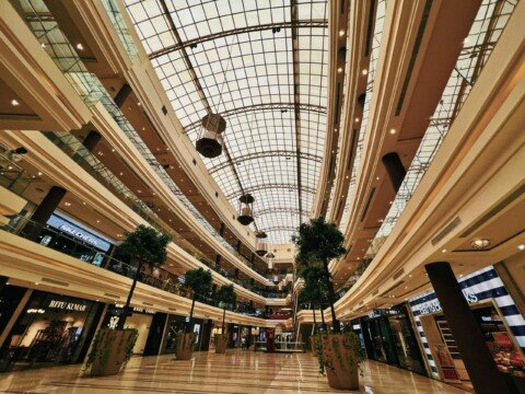 Glass-ceilinged shopping mall interior, representative of Kolkata's modern malls like South City and Quest Mall