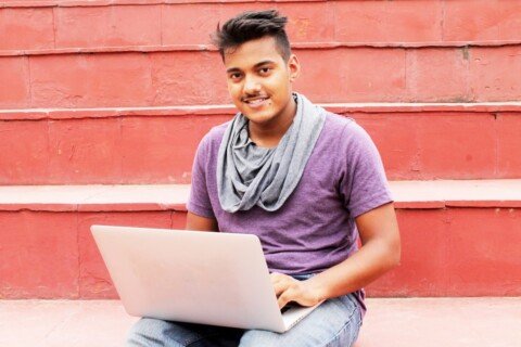 A person using a laptop, representing the KMC Digital Census 2027 self-enumeration process