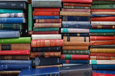 Piled secondhand books representing College Street Boi Para book market in Kolkata