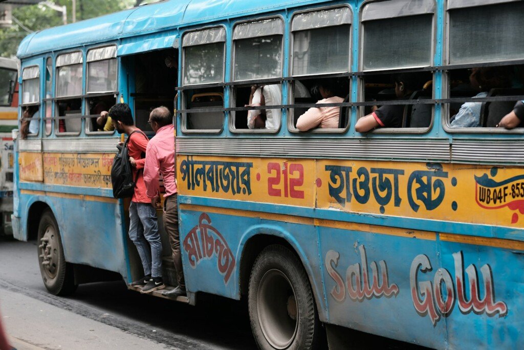 Passengers boarding a public bus in Kolkata