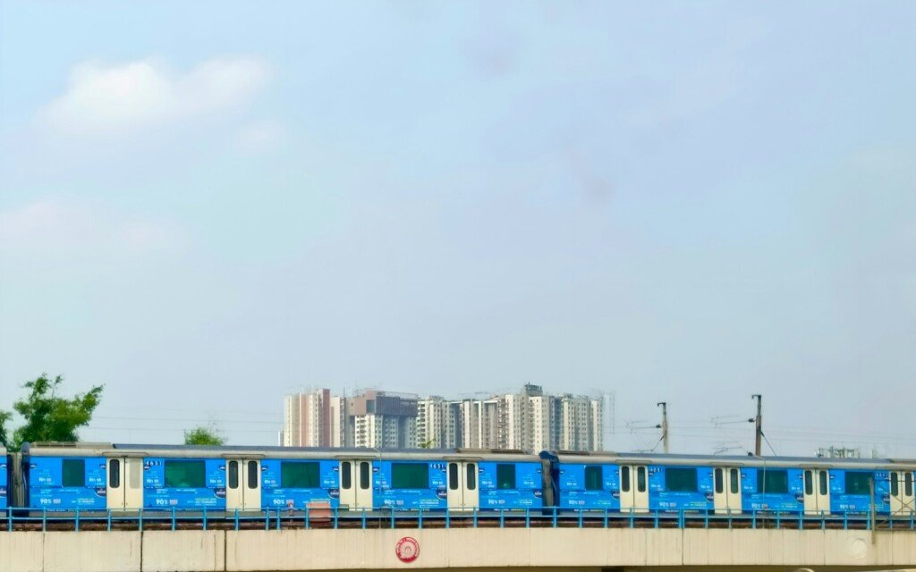 A Kolkata Metro blue line train crossing a bridge