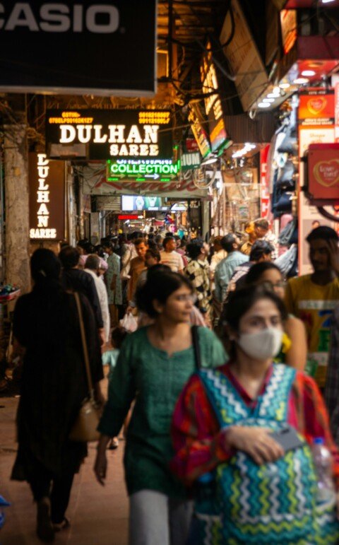 A crowded market street with saree shops, typical of Kolkata's shopping markets