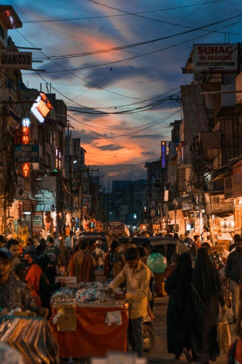 A busy market street at night, similar to New Market in Kolkata