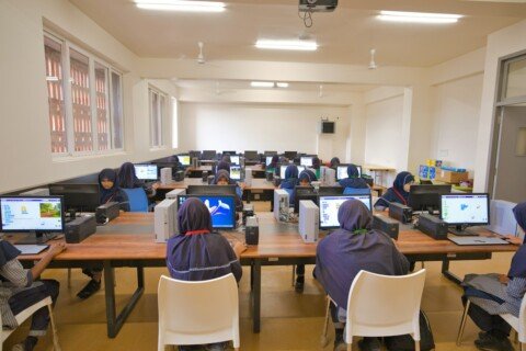 Students working at desktop computers in a college computer lab, representing BCA colleges in Kolkata