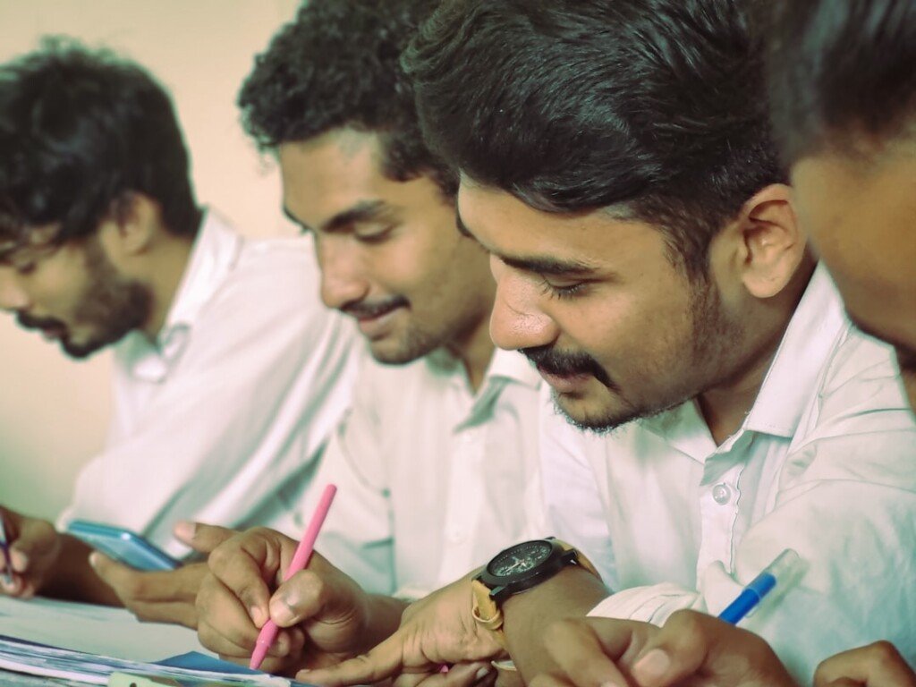 College students taking notes in a lecture hall, representing B.Com colleges in Kolkata