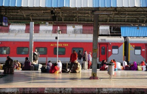 Passengers waiting on a crowded Indian railway platform beside a train, illustrating a guide to Sealdah station in Kolkata