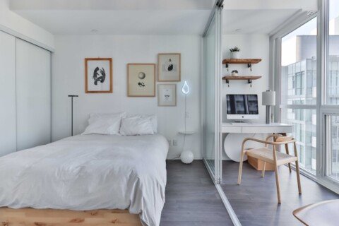Furnished co-living bedroom with a single bed, study desk and window, typical of managed co-living spaces in New Town, Kolkata