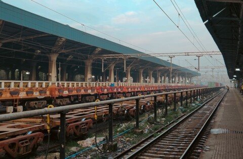 A quiet Indian railway station platform with tracks, illustrating the restored New Farakka line