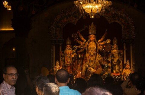Durga Puja pandal and crowds on a Kolkata street during the festival