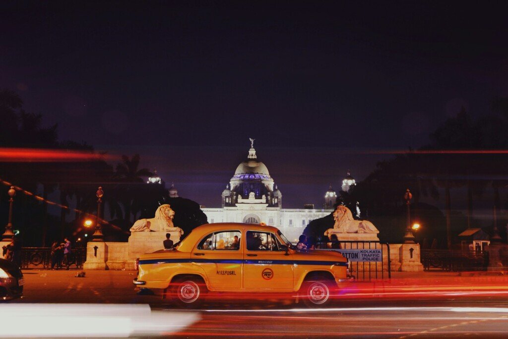 Traffic light trails on a Kolkata road at night, illustrating late night transport options in the city
