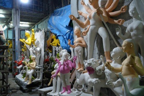 Kumartuli Kolkata: How to Visit the Potters' Quarter, Best Time, Metro Access & Photography Tips 26 Artisans sculpting a clay Durga idol in a Kumartuli workshop, Kolkata, ahead of Durga Puja