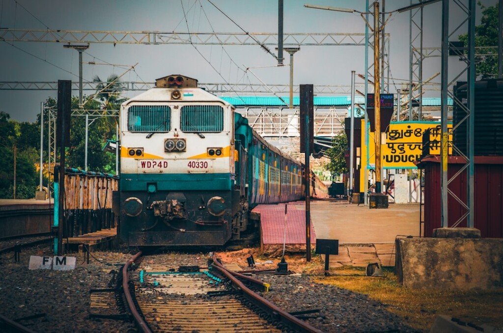A quiet Indian railway station platform with an empty track