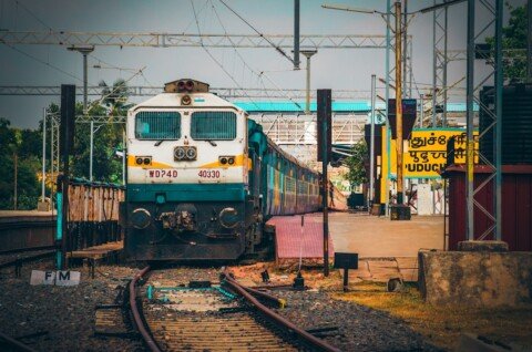 A quiet Indian railway station platform with an empty track