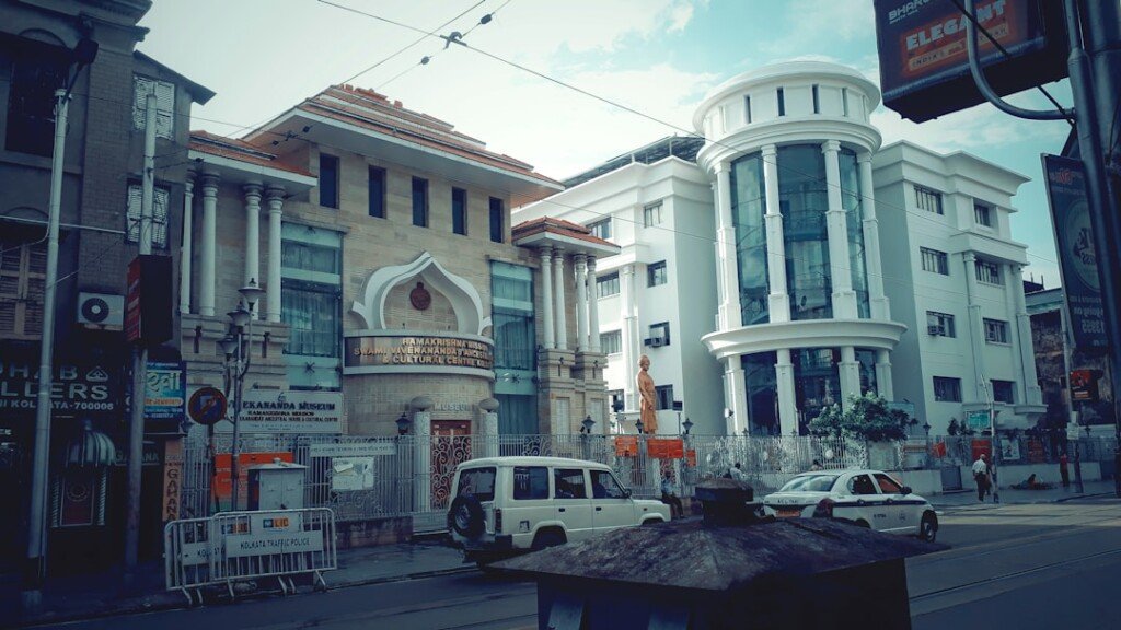 Residential street in Kolkata lined with apartment and PG buildings, illustrating the PG price guide by area