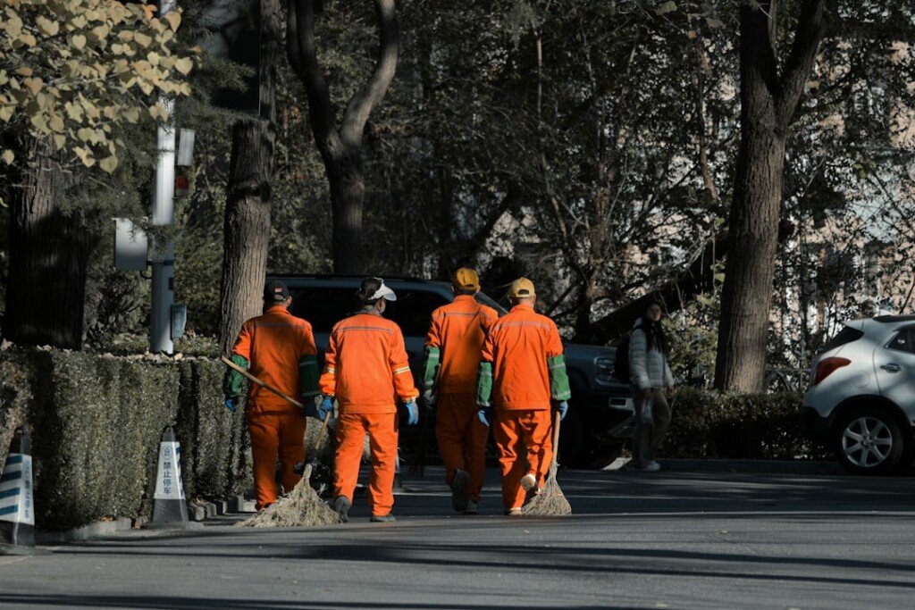 Sanitation workers with brooms on a Kolkata street during the KMC dengue drive