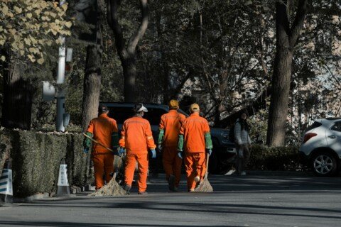 Sanitation workers with brooms on a Kolkata street during the KMC dengue drive
