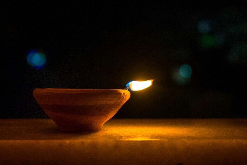 A lit clay diya lamp