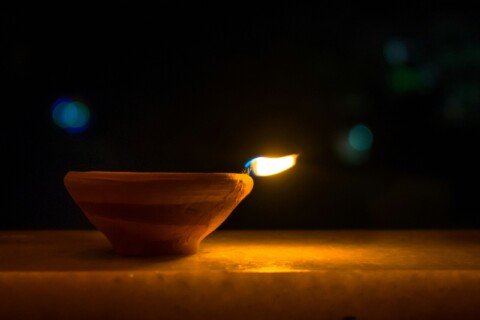 A lit clay diya lamp