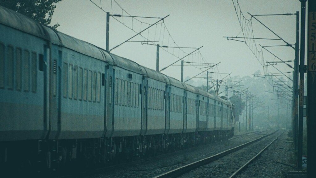 Passenger train running along a railway track, a typical journey for day trips from Kolkata