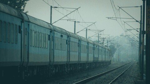 Passenger train running along a railway track, a typical journey for day trips from Kolkata