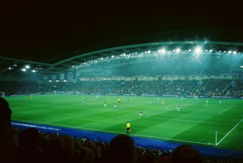 Football match under stadium floodlights at night, illustrating India vs Brazil at Salt Lake Stadium Kolkata