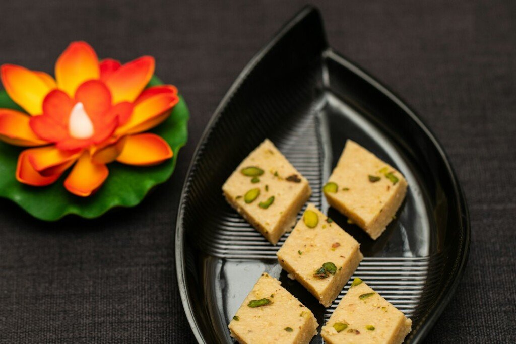 Assorted Indian mithai sweets arranged on a tray, representing Kolkata's winter nolen gur sweets