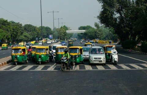 Taxis and cars waiting at an airport pickup area, the usual way to travel from Kolkata airport to the city