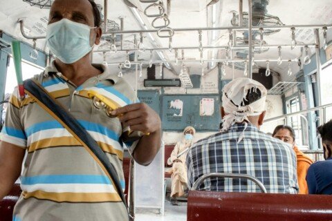 Commuter riding a Kolkata bus, representing everyday public transport and commute apps