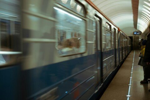 Metro train passing through an underground station platform, illustrating the Kolkata metro lines