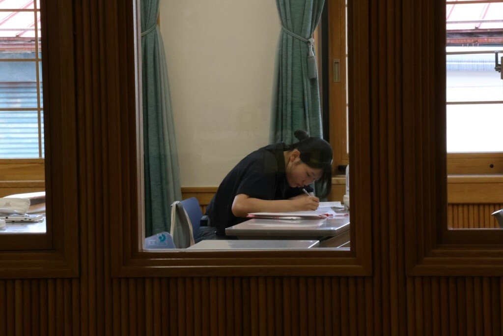 Student studying at a desk with books, representing student PG accommodation near Kolkata universities