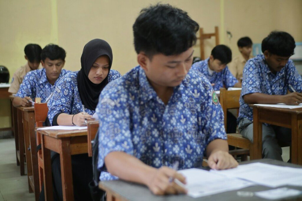 Students sitting an entrance test in a classroom