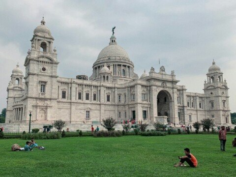 White marble dome and facade of Victoria Memorial in Kolkata seen from the gardens