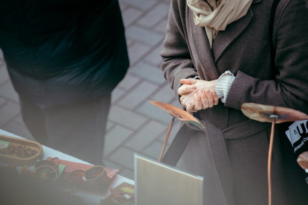 Colourful woollen scarves and winter wear displayed on a market stall